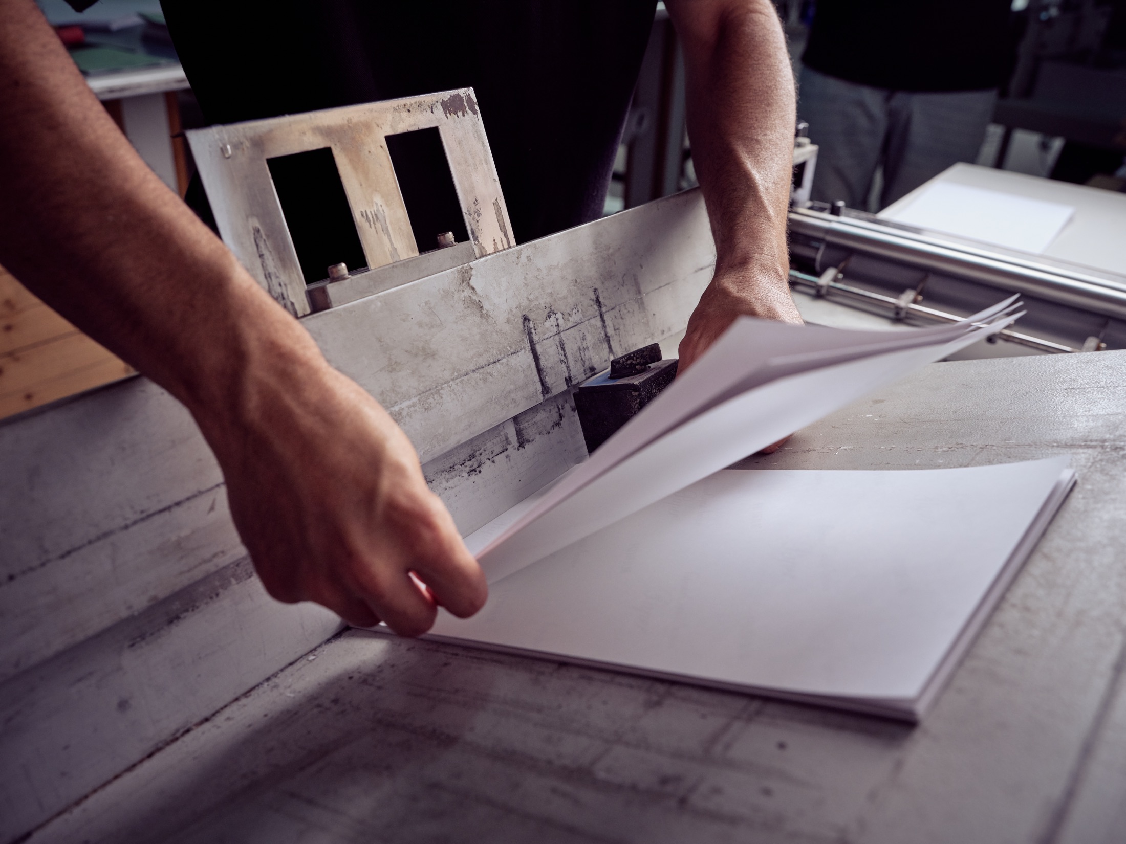 Paper being aligned in a printing workshop